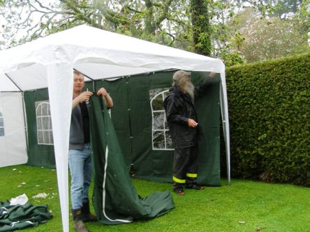 The kind neighbours, erecting a temporary gazebo (with the doubly kind neighbour to the left who happens to own said item)