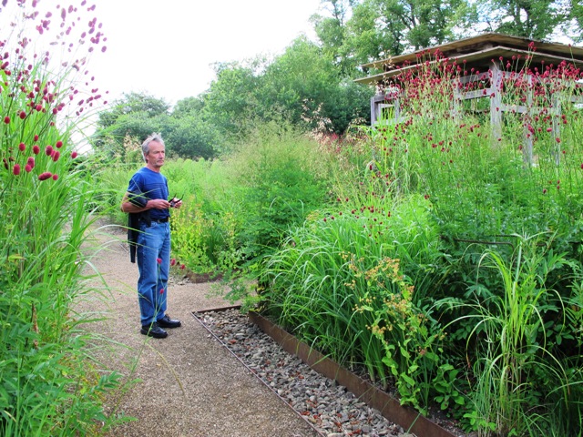 Mark, standing in the elegant grass garden at Bury Court