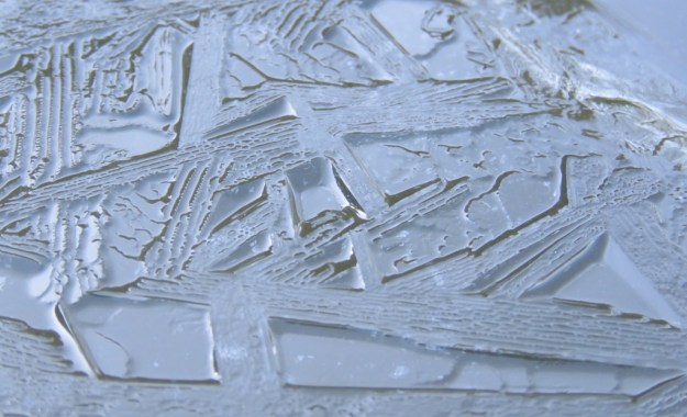 Ripples on the ice formed on a farm trough 
